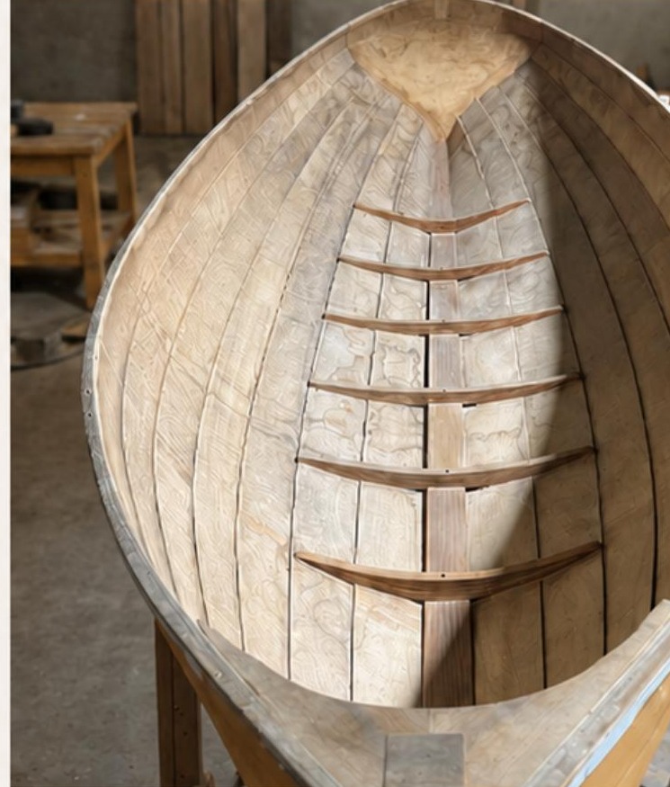 Interior of a hand-planked wooden boat hull under construction